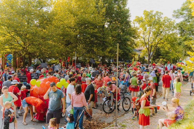 crowd of people in tomato costumes at the tomato art festival