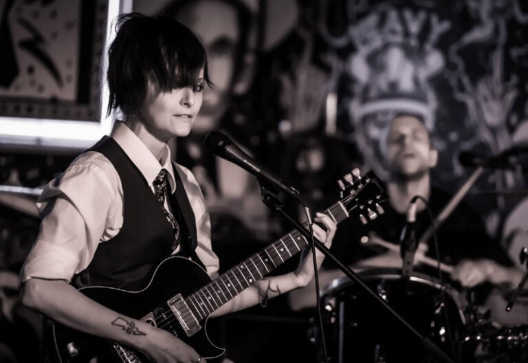 Buick Audra playing guitar with Friendship Commanders