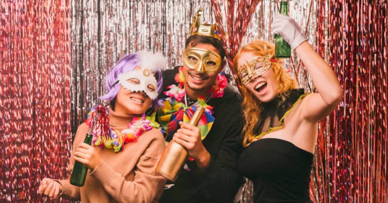 Low angle friends in costumes having fun in holidays sober