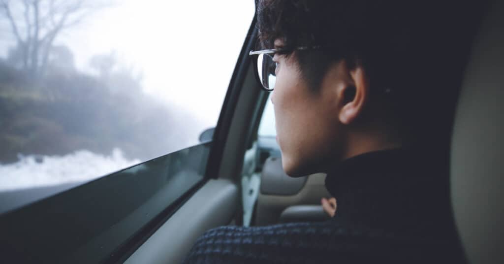 Asian person looks out the window. 7 Ways to Beat the Winter Blahs, via Pixel