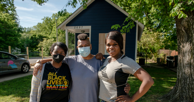 My Sistah's House's Kayla Gore and team/volunteers in front of one of their homes outside