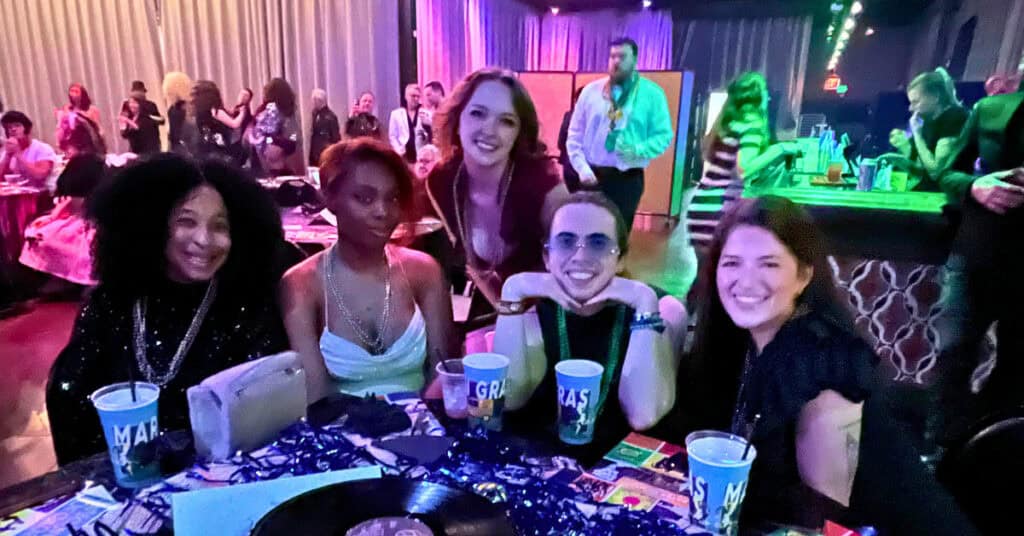 Friends smiling at The Mystic Krewe of Pegasus Ball