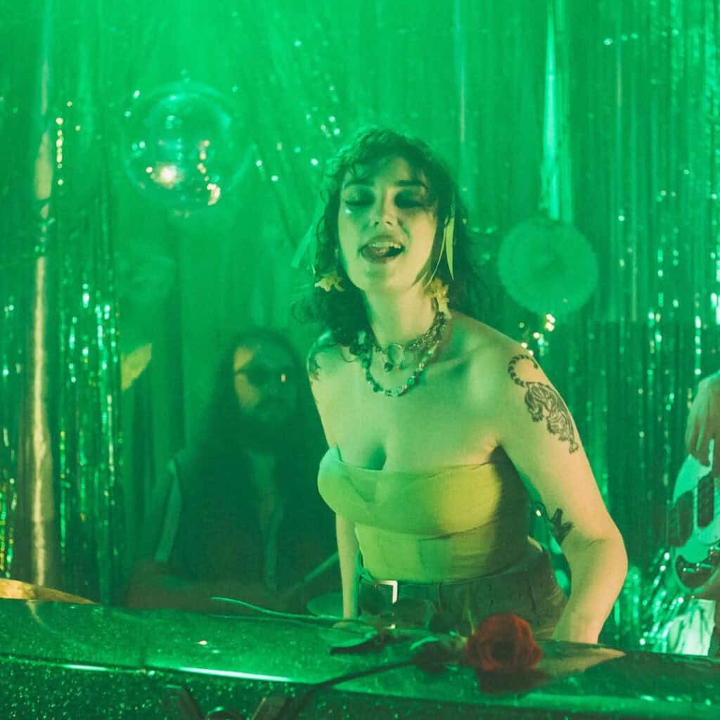 Green image of Louise Page at Current show, via Louise Page Facebook for Memphis LGBTQ Valentine's Day round up