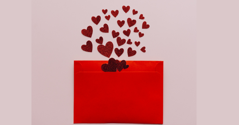 Graphic of bright red hearts coming out of a red card for our Valentine's Day Card round up