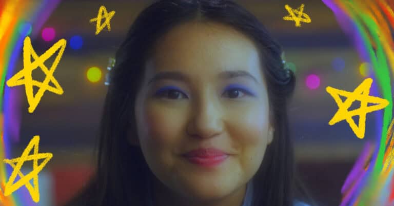 – Jess (Asahi Hirano) beams at Twinkie while getting her makeup done. Credit: DP – Olivia Wilson, Colorists – Chris Chew & A.K. Moore