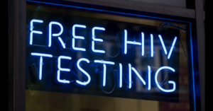 Glowing sign reads Free HIV Testing