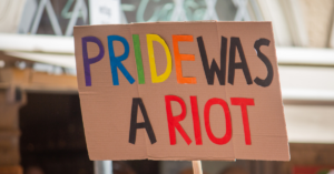 Protest sign reads Pride Was a Riot