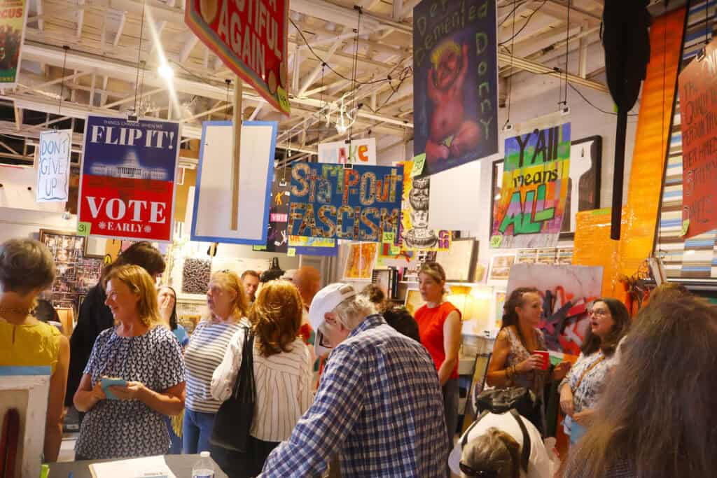 People browse colorful signs and posters at a Memphis art fair. — focuslgbt.com