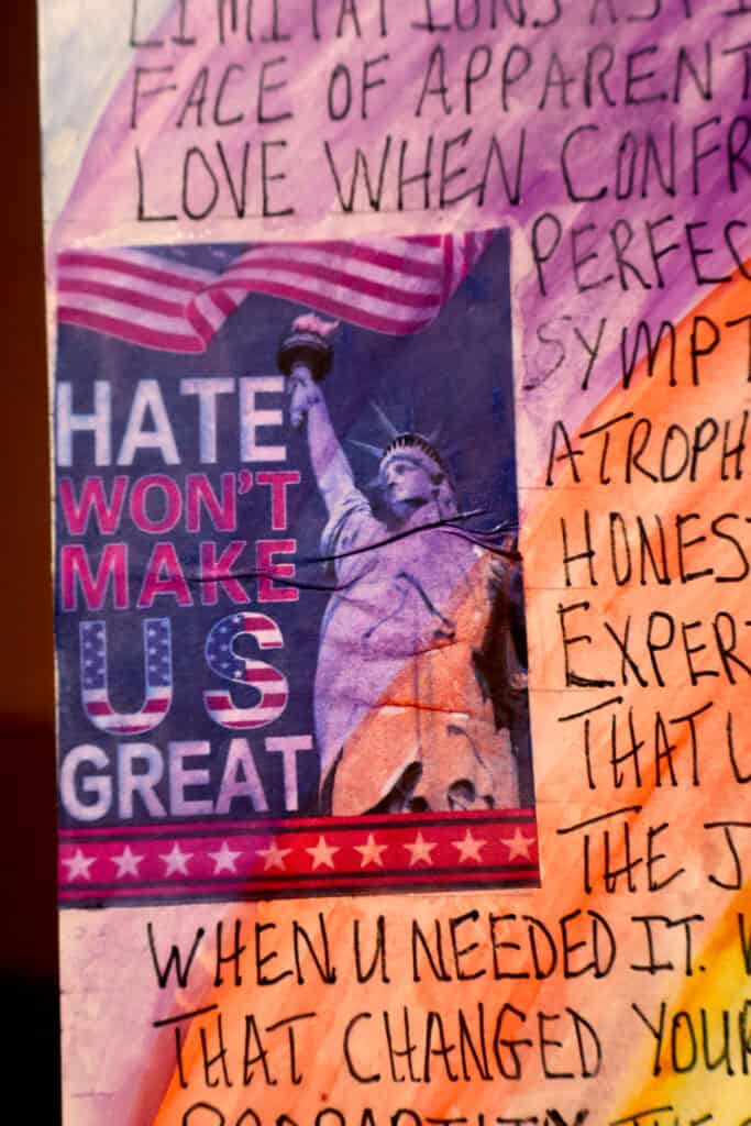 Protest sign with Statue of Liberty holding a rainbow flag and 'HATE WON'T MAKE US GREAT' text. — focuslgbt.com