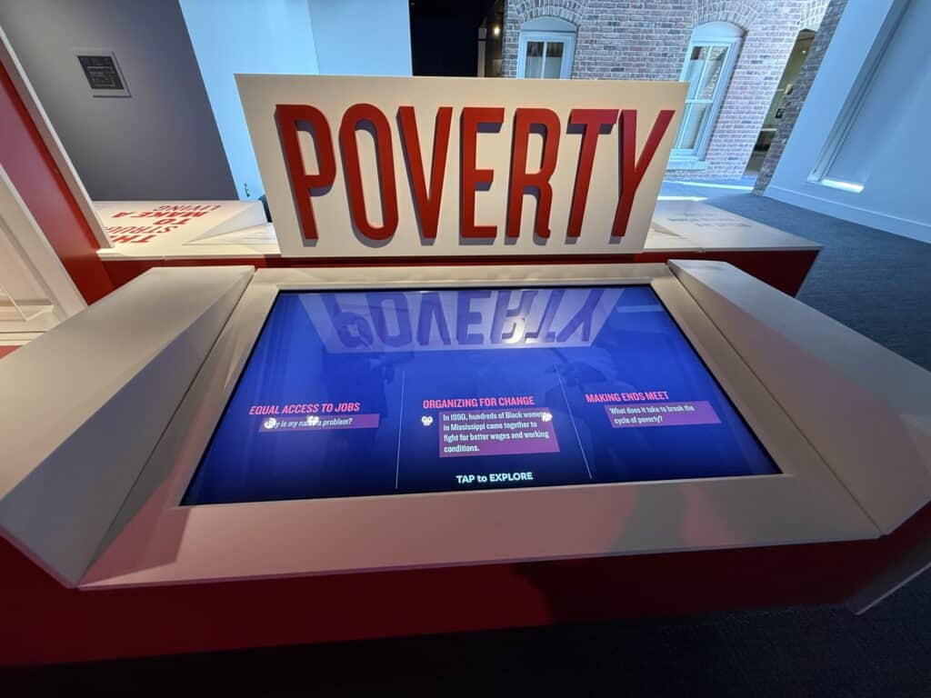 Interactive display with 'POVERTY' sign at the Civil Rights Museum in Memphis. — focuslgbt.com