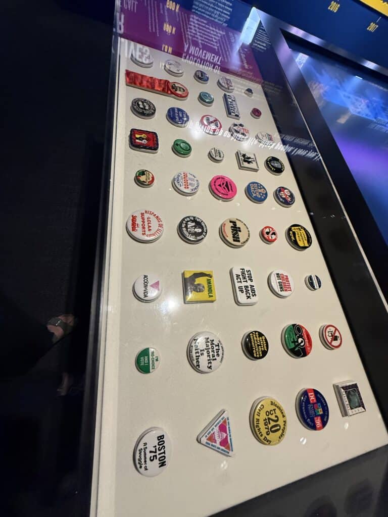 Display of various pins and badges at the museum exhibit in Memphis. — focuslgbt.com