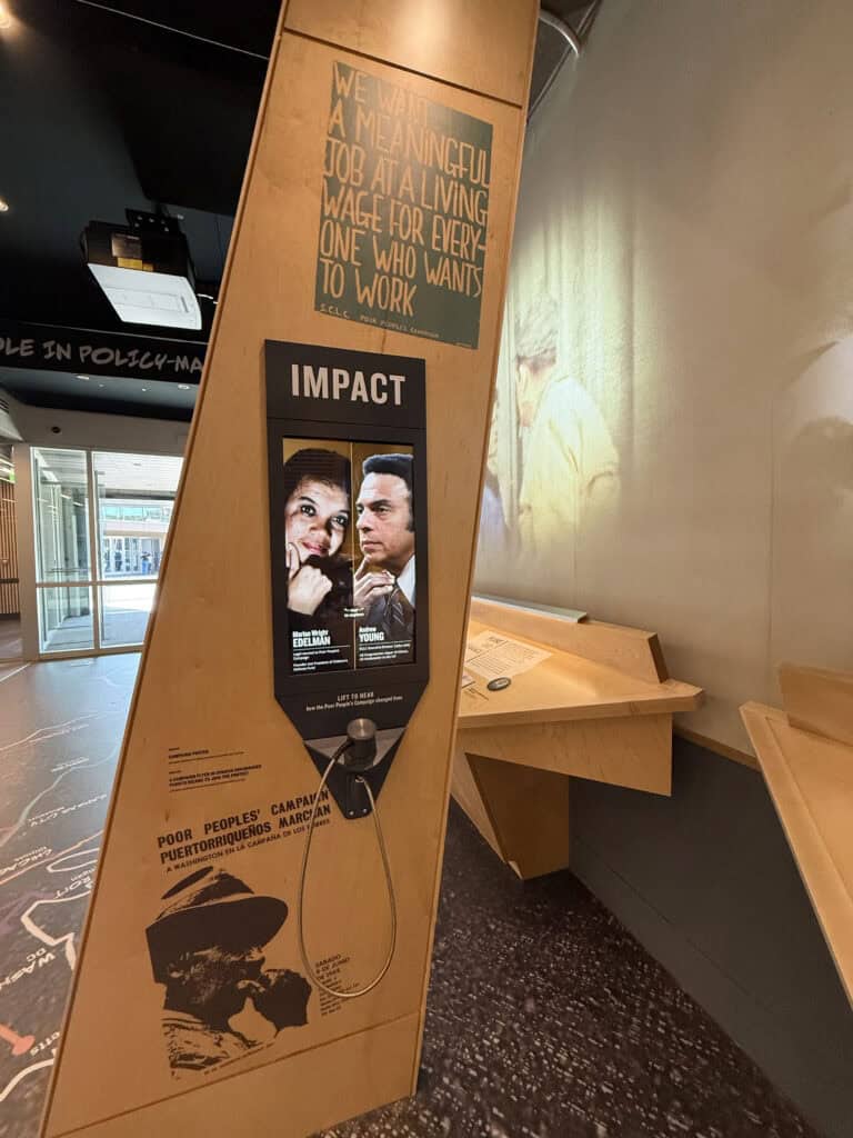 Posters about impact and social issues on a wooden stand in a cafe. — focuslgbt.com