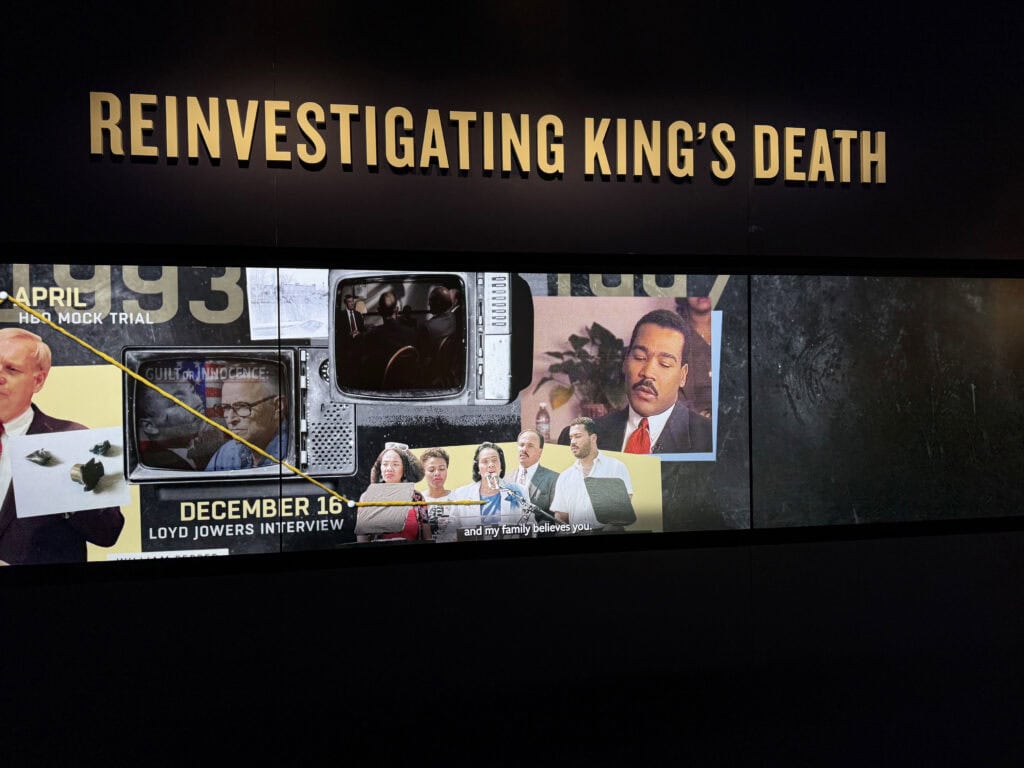 Exhibit title 'Reinvestigating King's Death' displayed on a screen. — focuslgbt.com