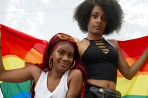 Two women hold a rainbow flag at a pride event in Memphis. — focuslgbt.com