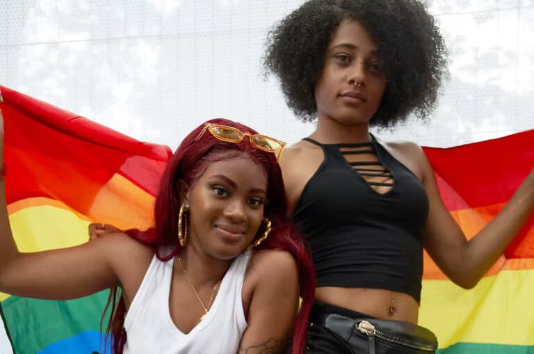 Two women hold a rainbow flag at a pride event in Memphis. — focuslgbt.com