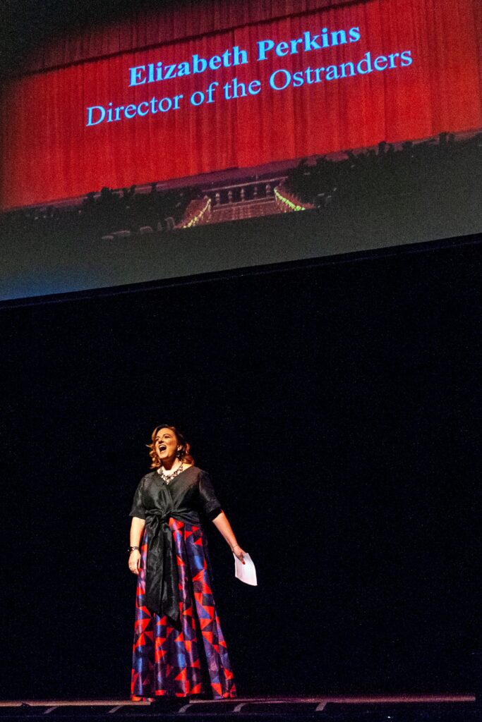 Performer in a black top and colorful skirt on stage at Memphis theatre event. — focuslgbt.com