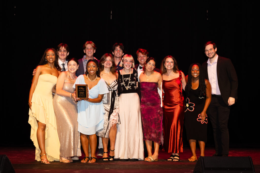 Group of people on stage holding awards and wearing formal attire. — focuslgbt.com